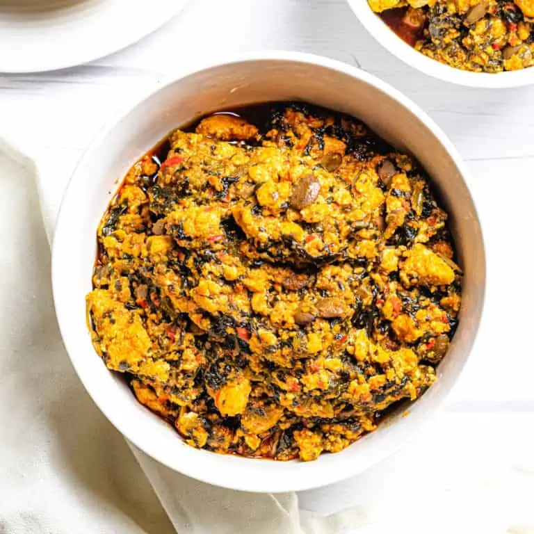 Nigerian egusi soup in a white bowl