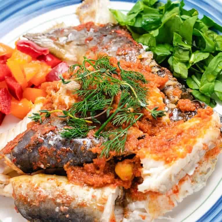 Baked Whole Catfish made in the oven with peppers and fresh herbs.