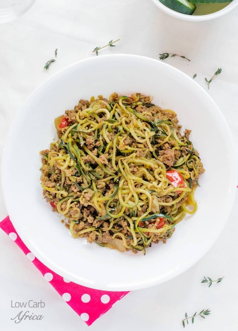 plate of Zucchini and Ground Beef stir fry on a white background.