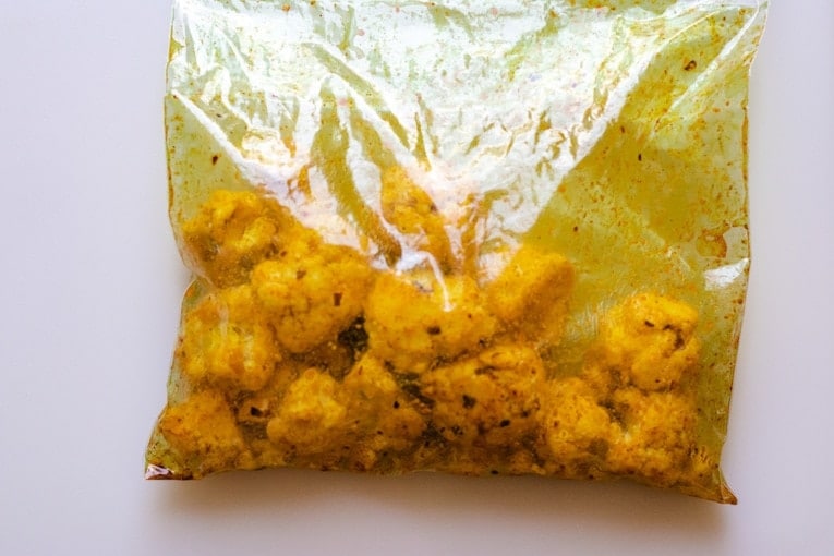 Cauliflower mixed with oil, turmeric and other spices