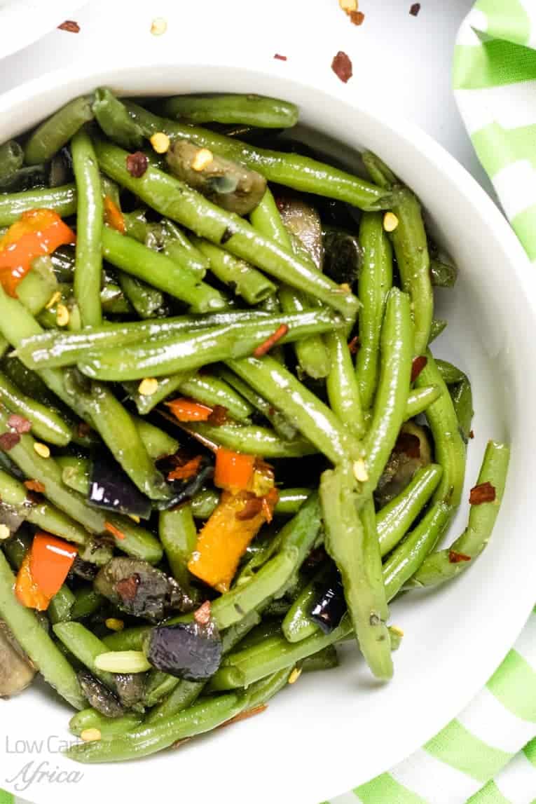 close up image for sauteed green beans and mushrooms.