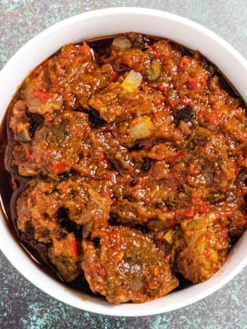Nigerian Ofada Ayamase Stew in a white bowl.