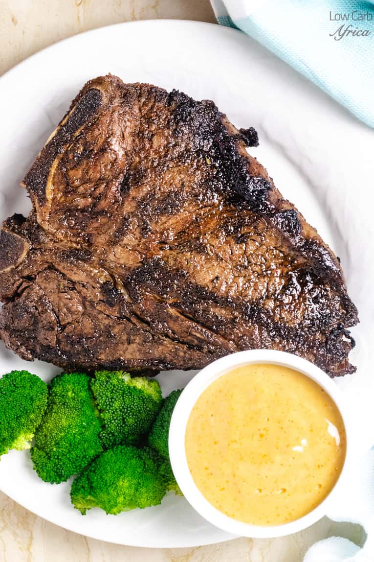 t-bone steak grilled with broccoli and spicy mayo.