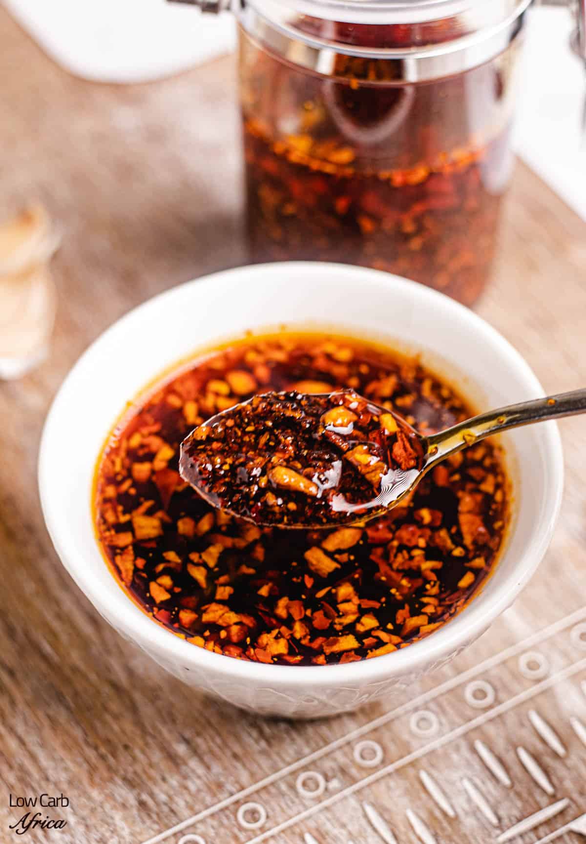 a spoon scooping up some garlic chili oil.