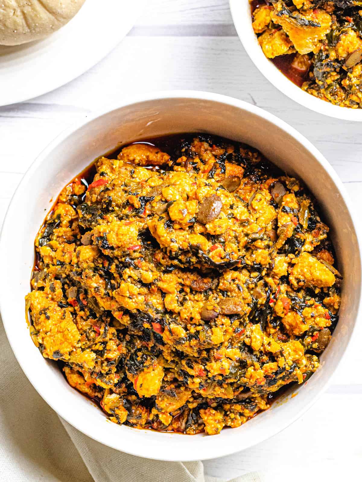 bowl of egusi soup on a white background
