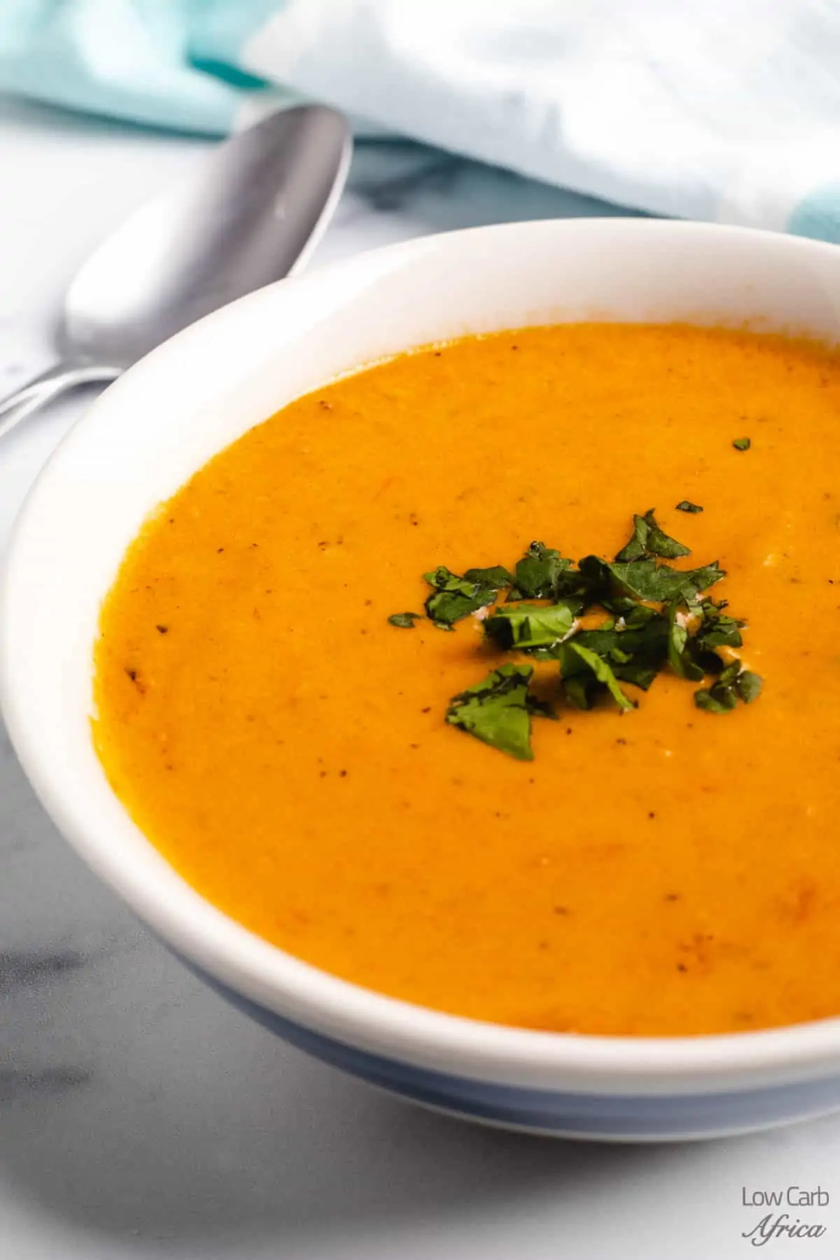 creamy keto tomato soup in a white bowl