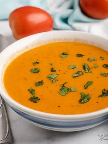 tomato soup in a bowl sprinkled with herbs
