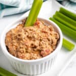 bowl of spicy sausage dip with celery