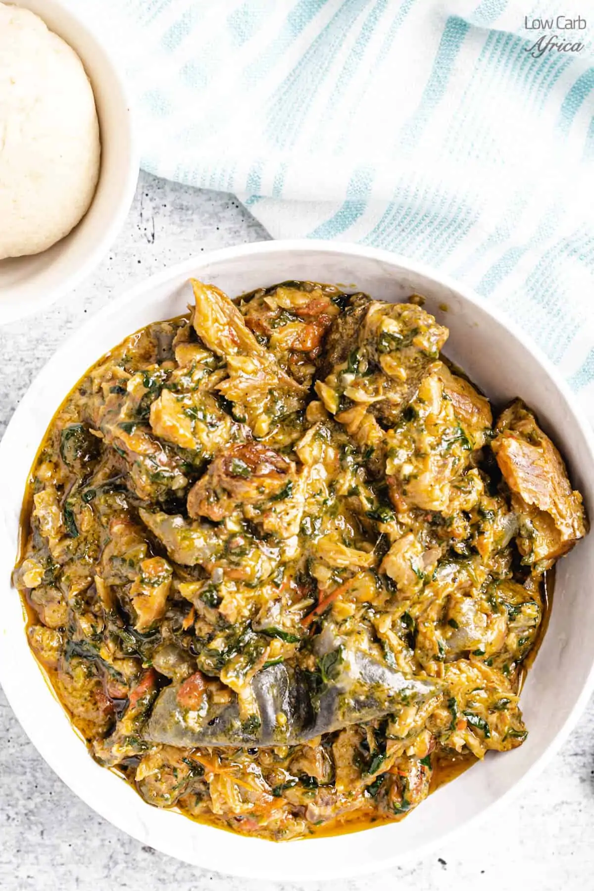 Fumbwa spinach stew on a white plate