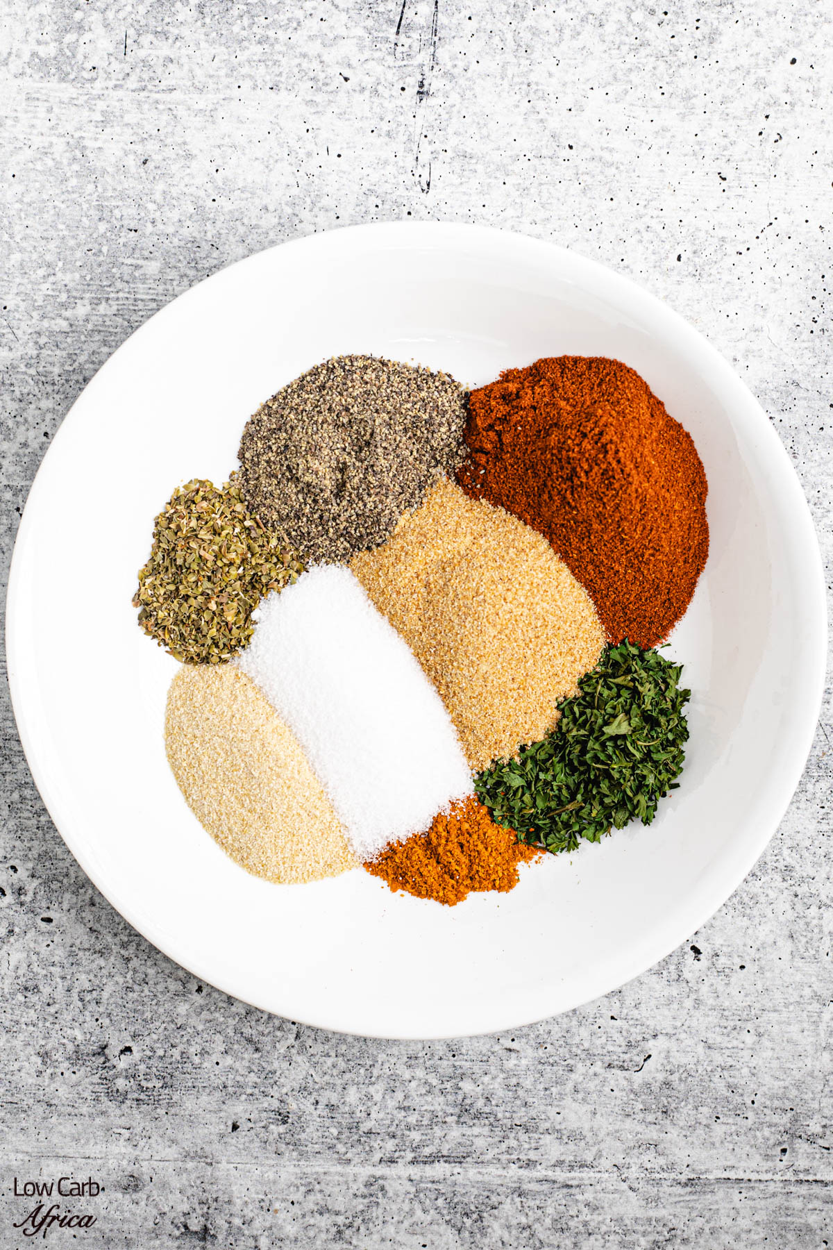 chicken seasoning ingredients on a white plate.