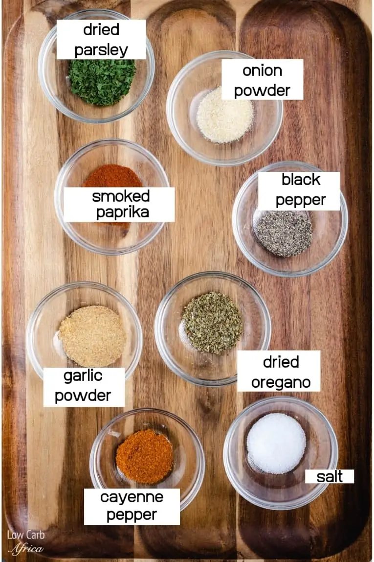 Ingredients for chicken seasoning recipe on wooden tray.