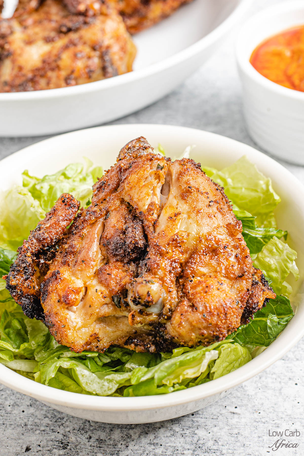 Air Fryer Bone-In Chicken Thighs on a bed of lettuce