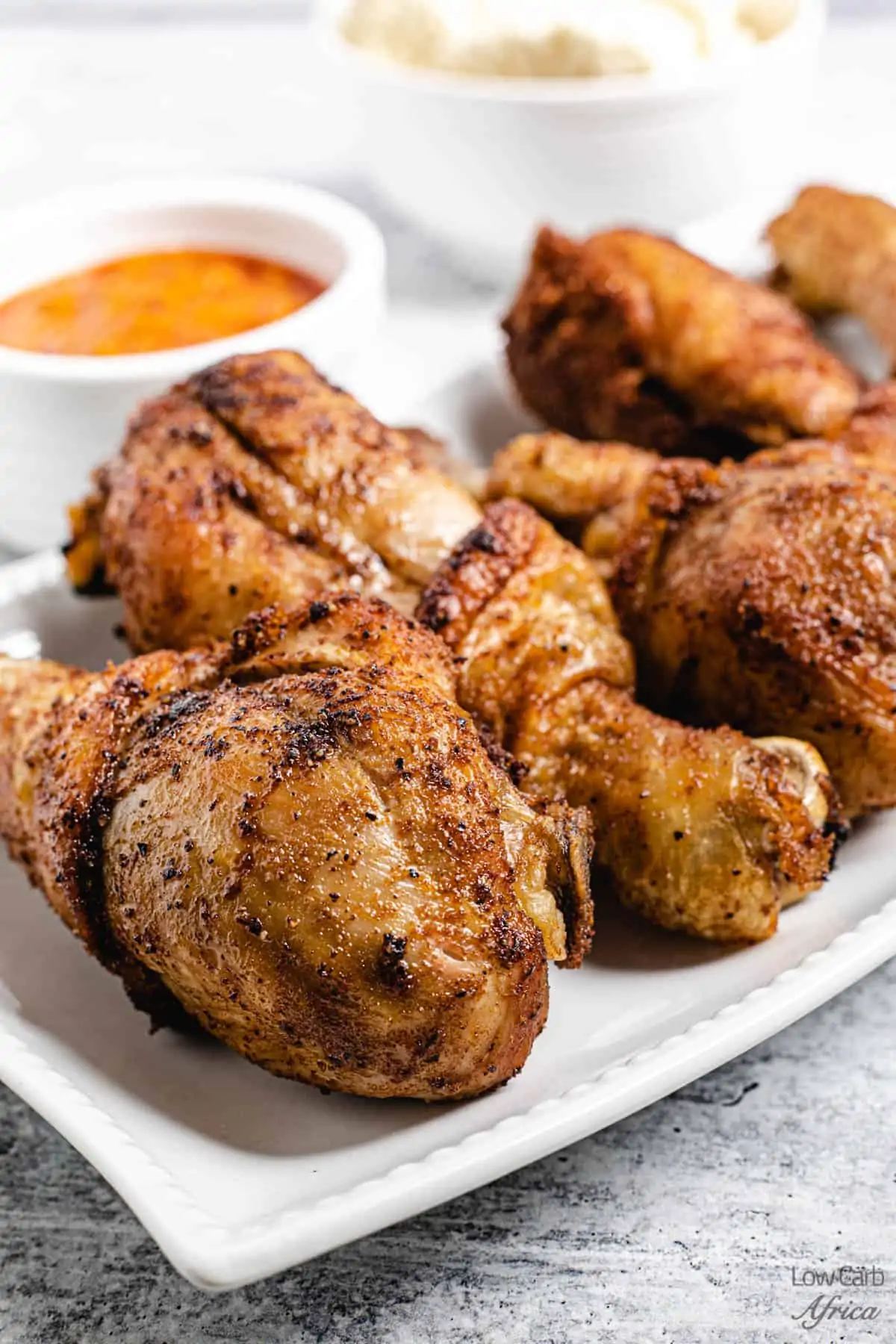 fried chicken drumsticks with hot sauce