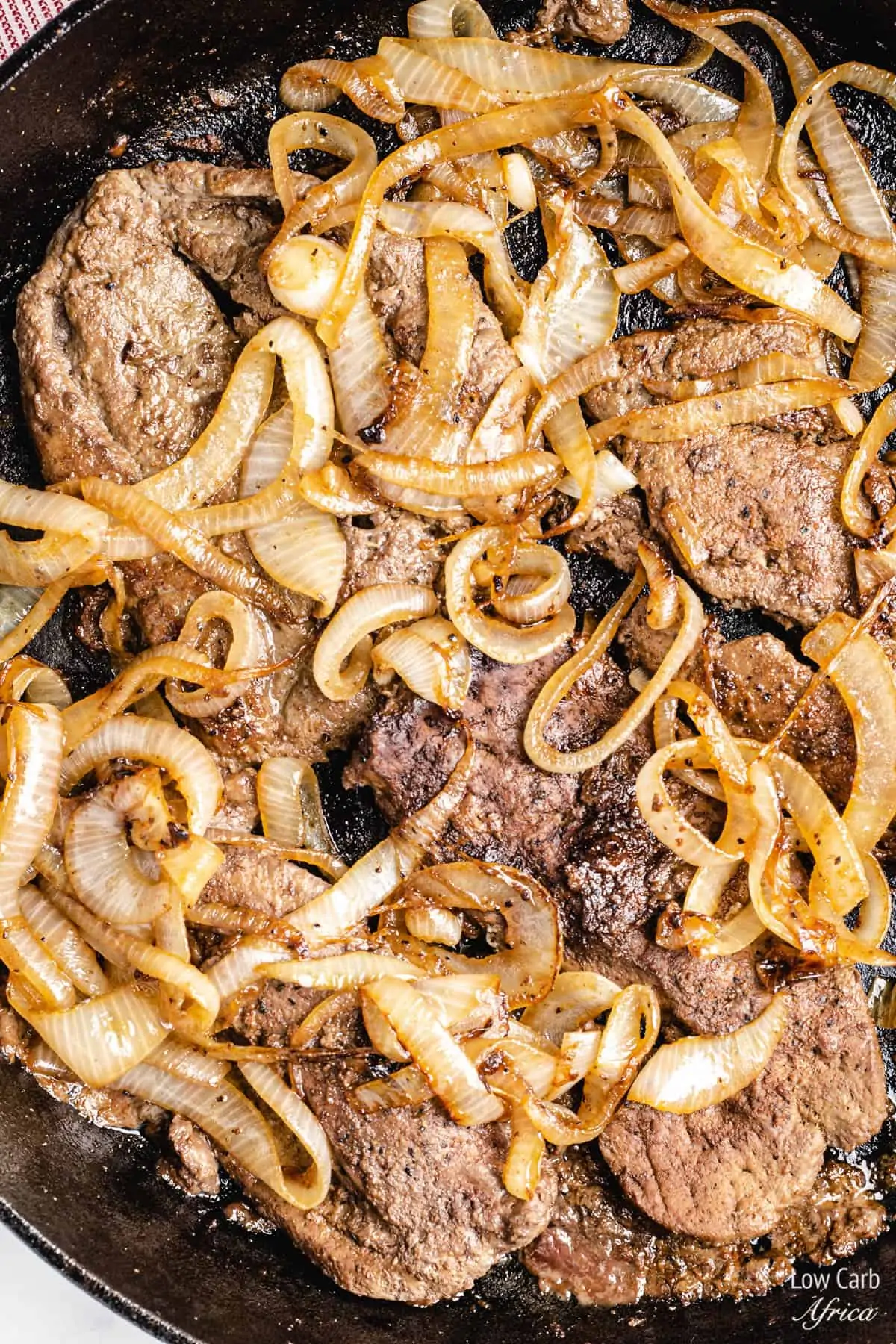 liver and onions recipe in a cast iron skillet.