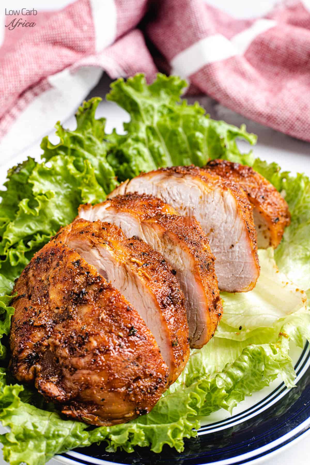 sliced air fryer turkey breast served on a bed of lettuce