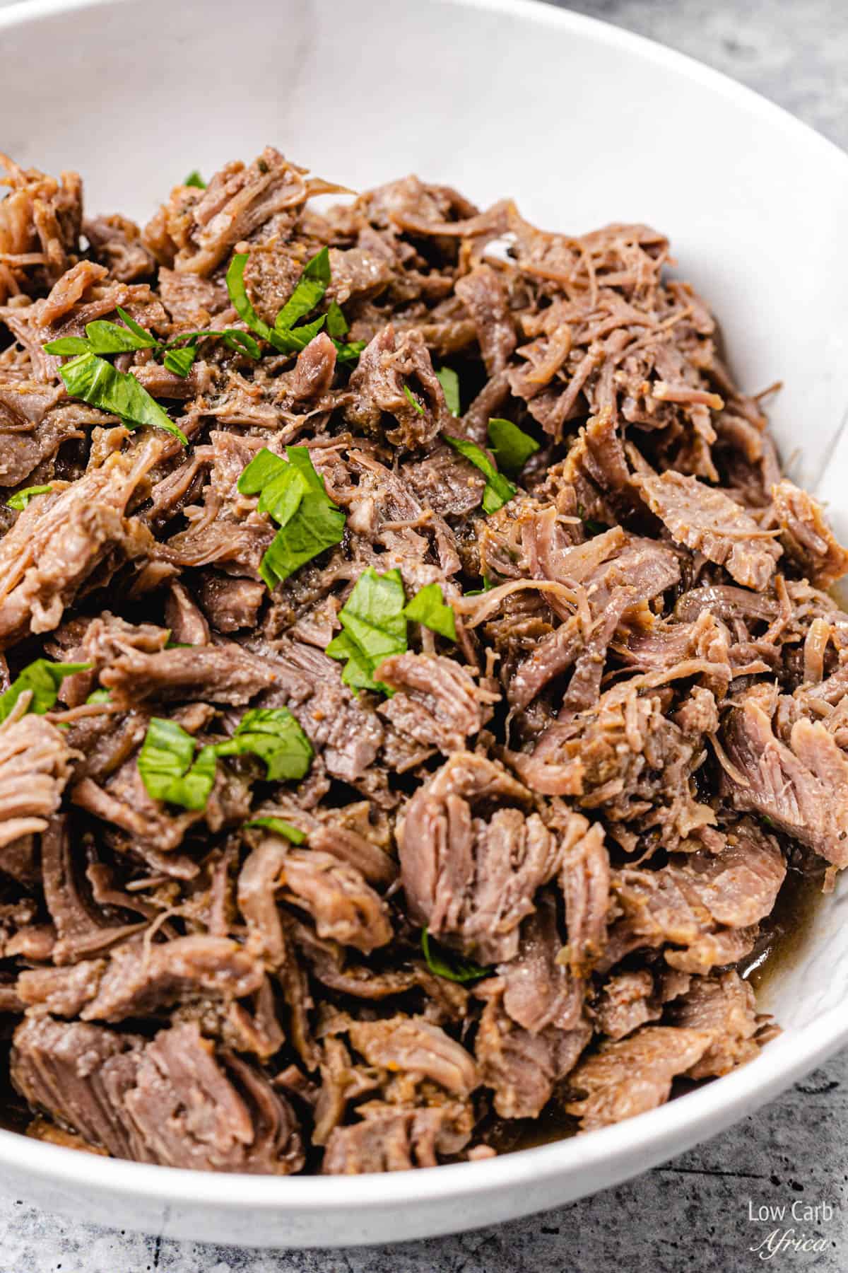 shredded beef in a white bowl