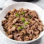 Instant Pot Shredded Beef shredded beef in a white bowl