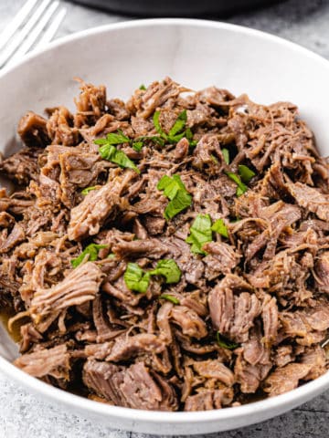 shredded beef in a white bowl
