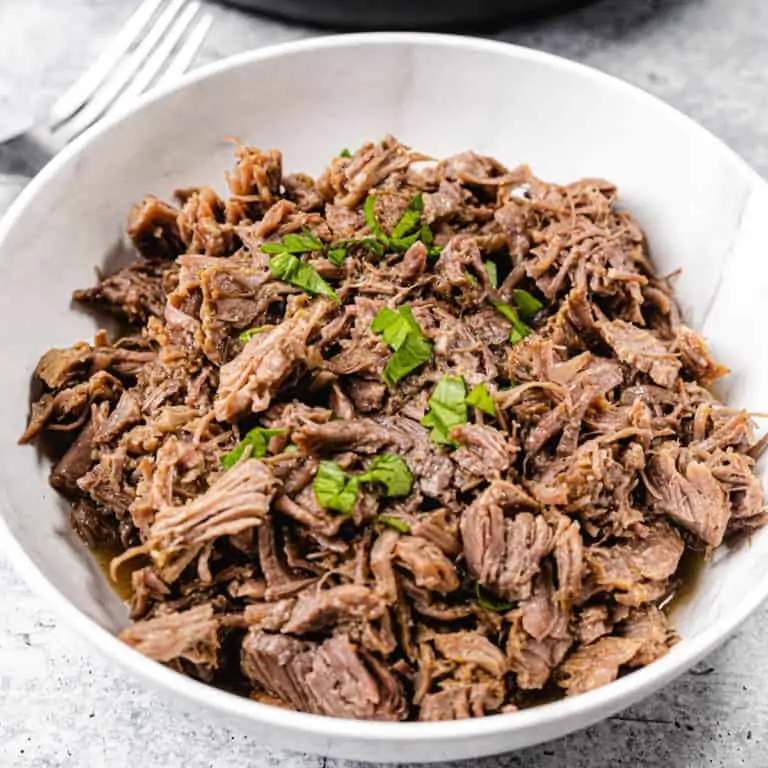 shredded beef in a white bowl