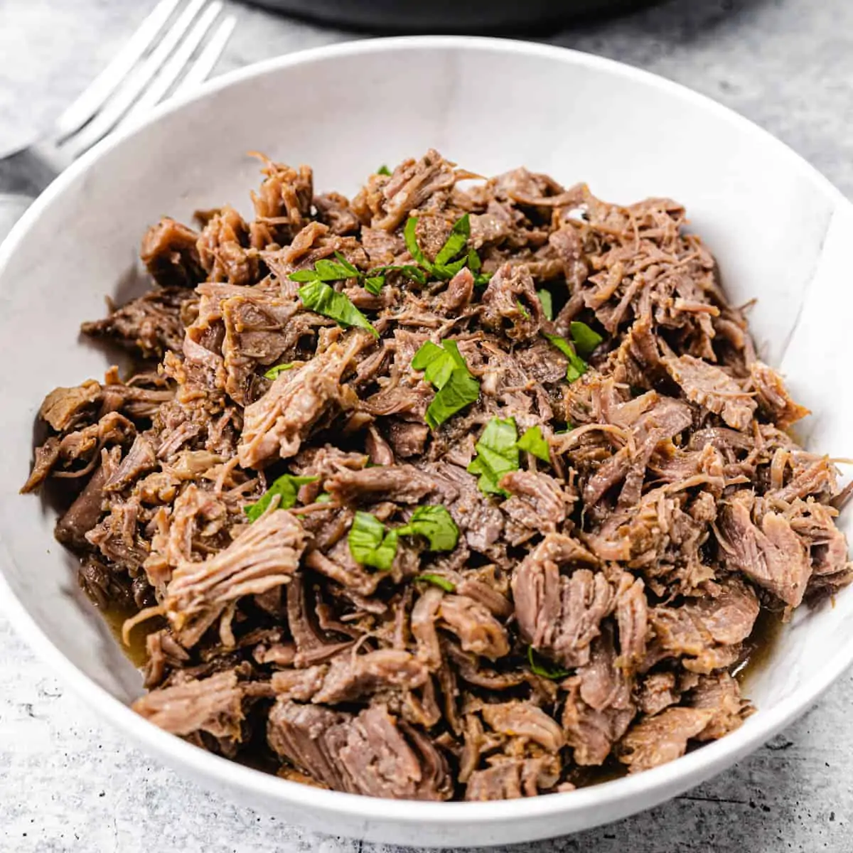 shredded beef in a white bowl