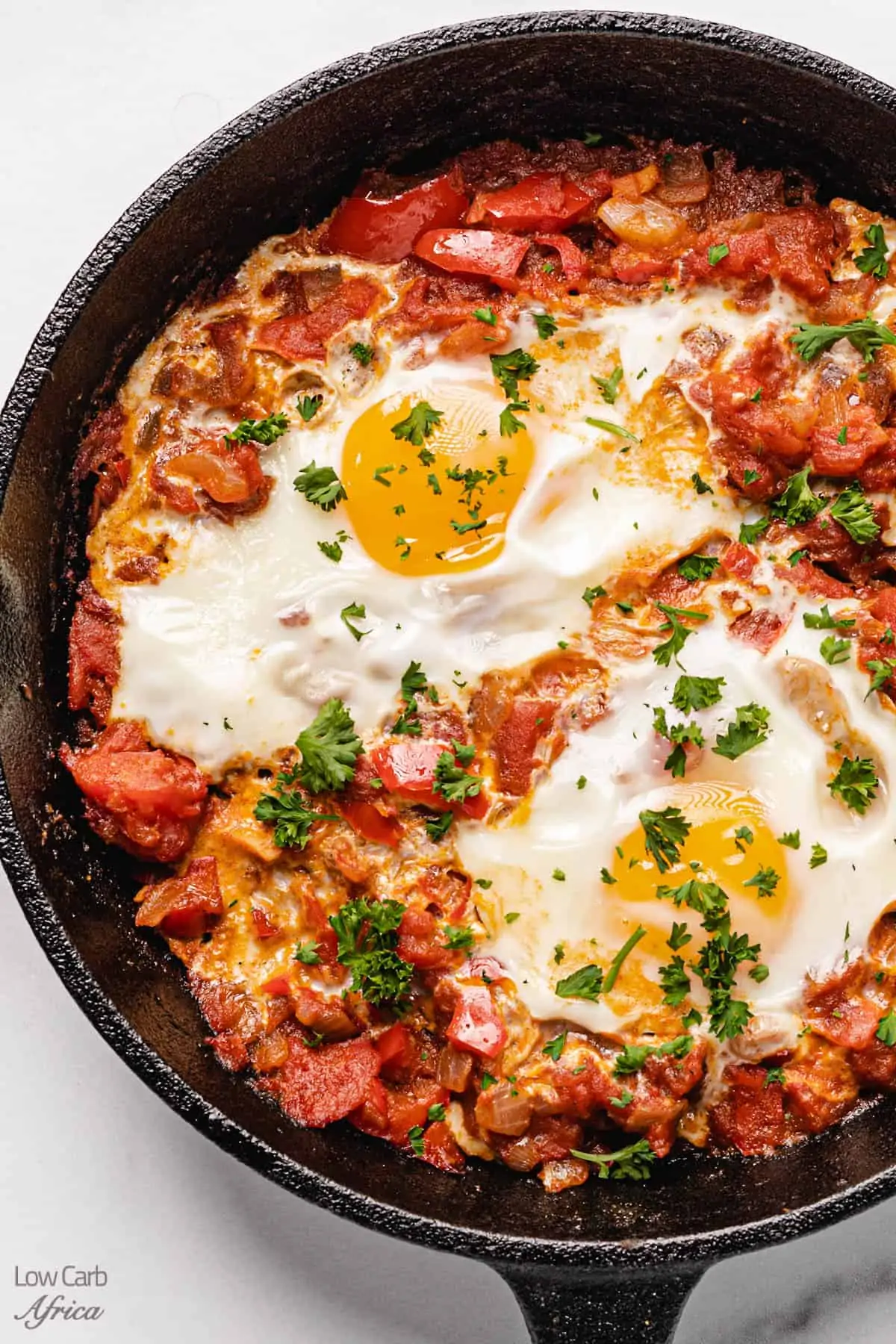 closeup of african poached eggs in pan.