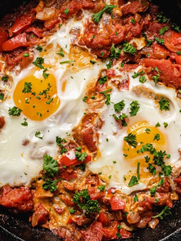 closeup of shakshuka in cast iron pan