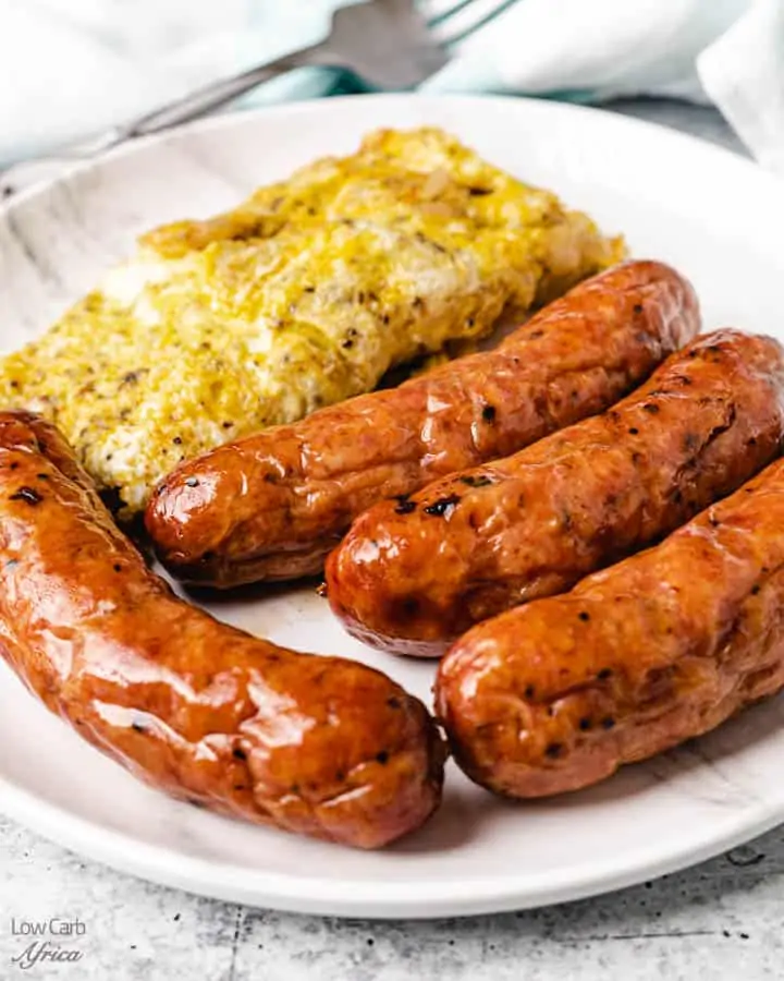 sausages served with omelet on a white plate