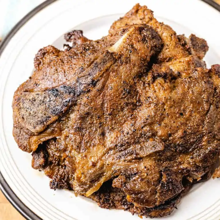 ninja foodi pork chops on a white plate