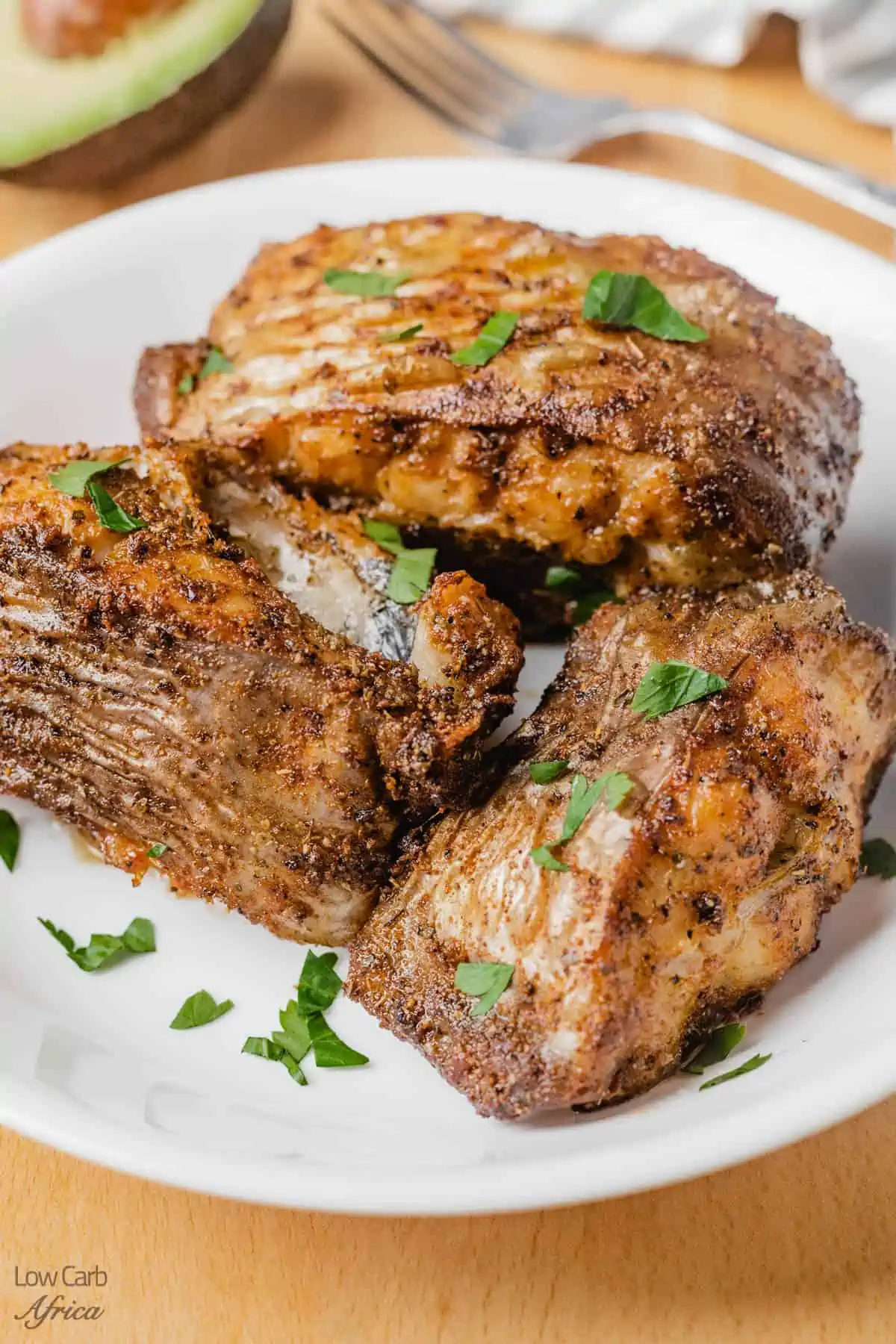 fried catfish steaks on a white plate