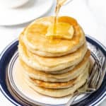 pouring syrup on keto pancakes
