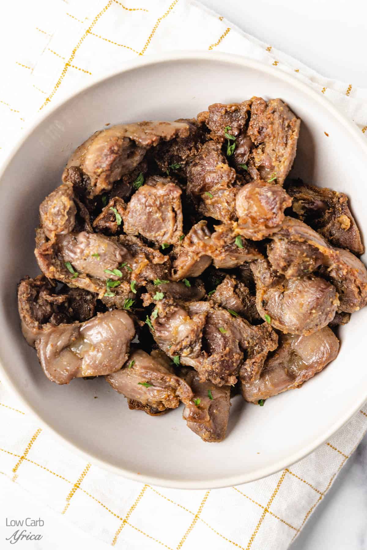 air fryer chicken gizzard on a white plate.