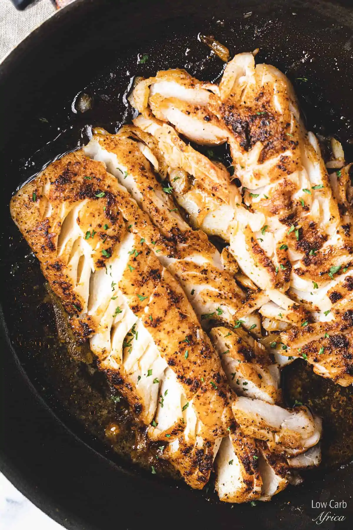 pan seared codfish in a skillet