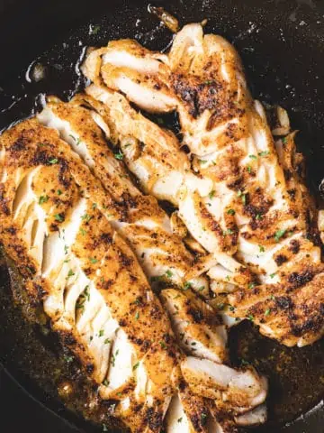 pan fried cod fish in cast iron pan