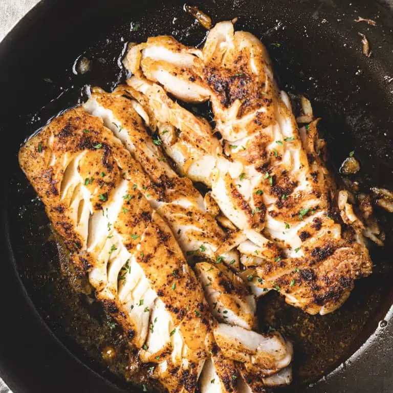 pan fried cod fish in cast iron pan