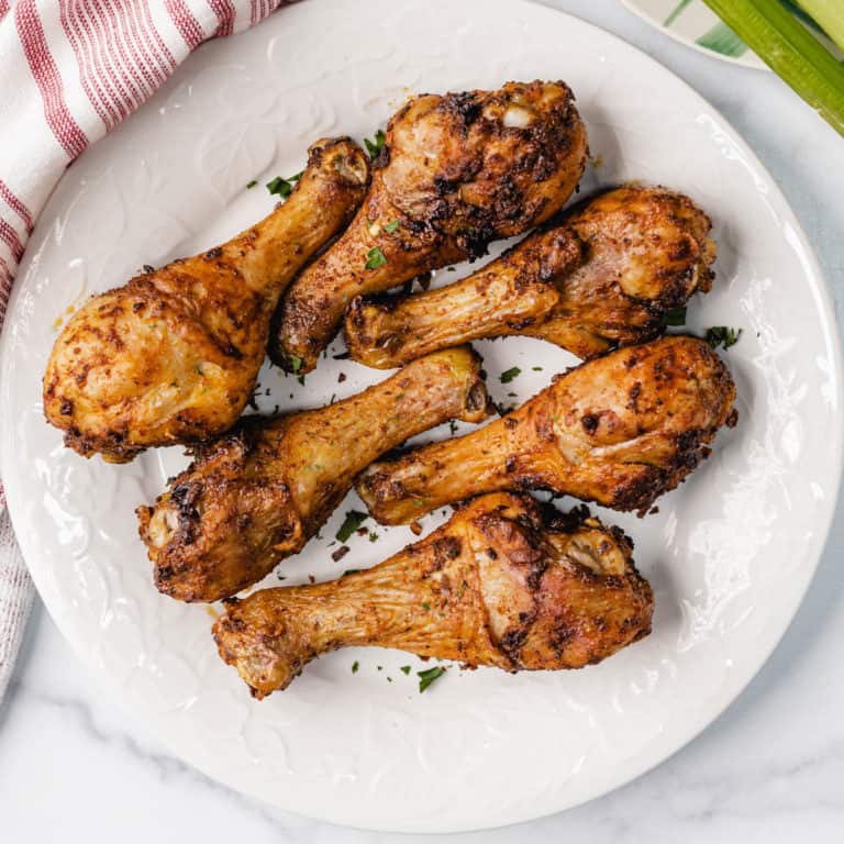 air fryer chicken legs in a white plate