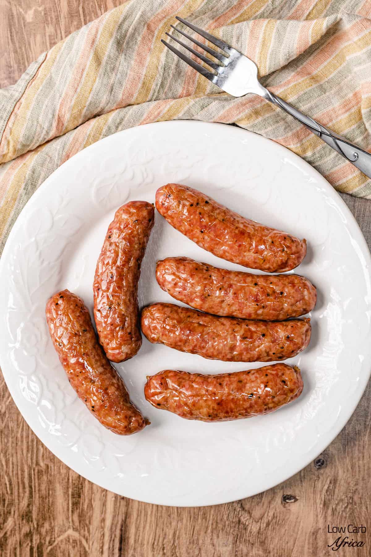 Sausage baked in the oven on a white plate