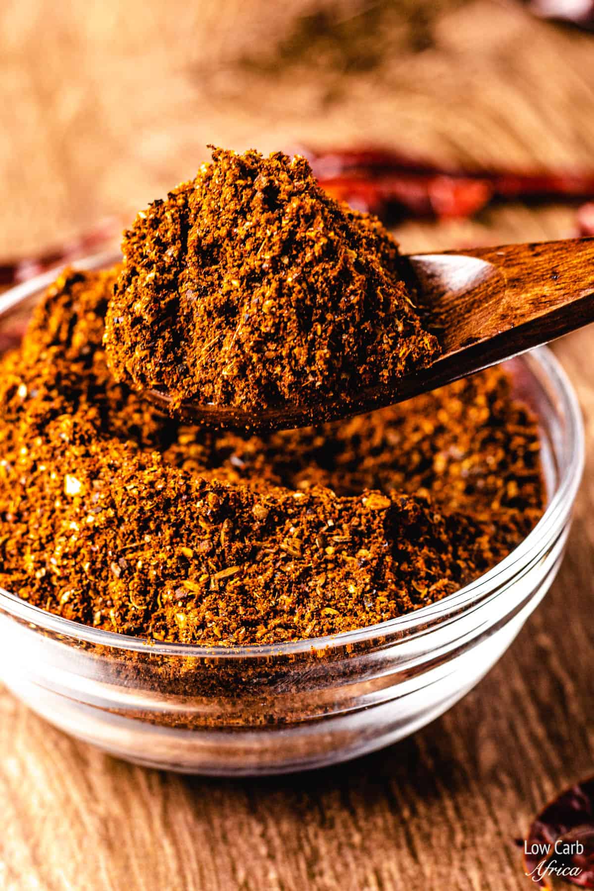 harissa powder with spoon scooping out spice