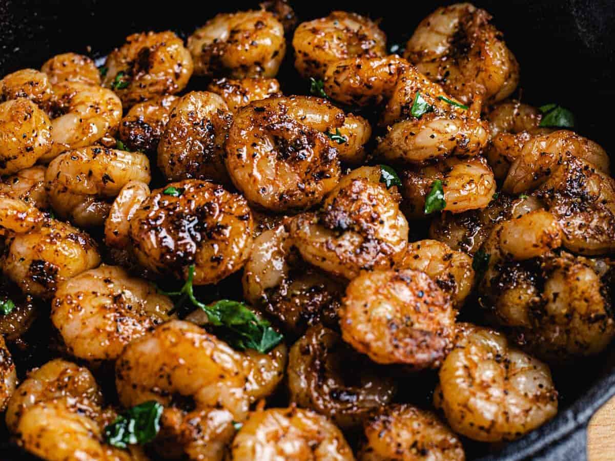 shrimps with spices on a cast iron skillet