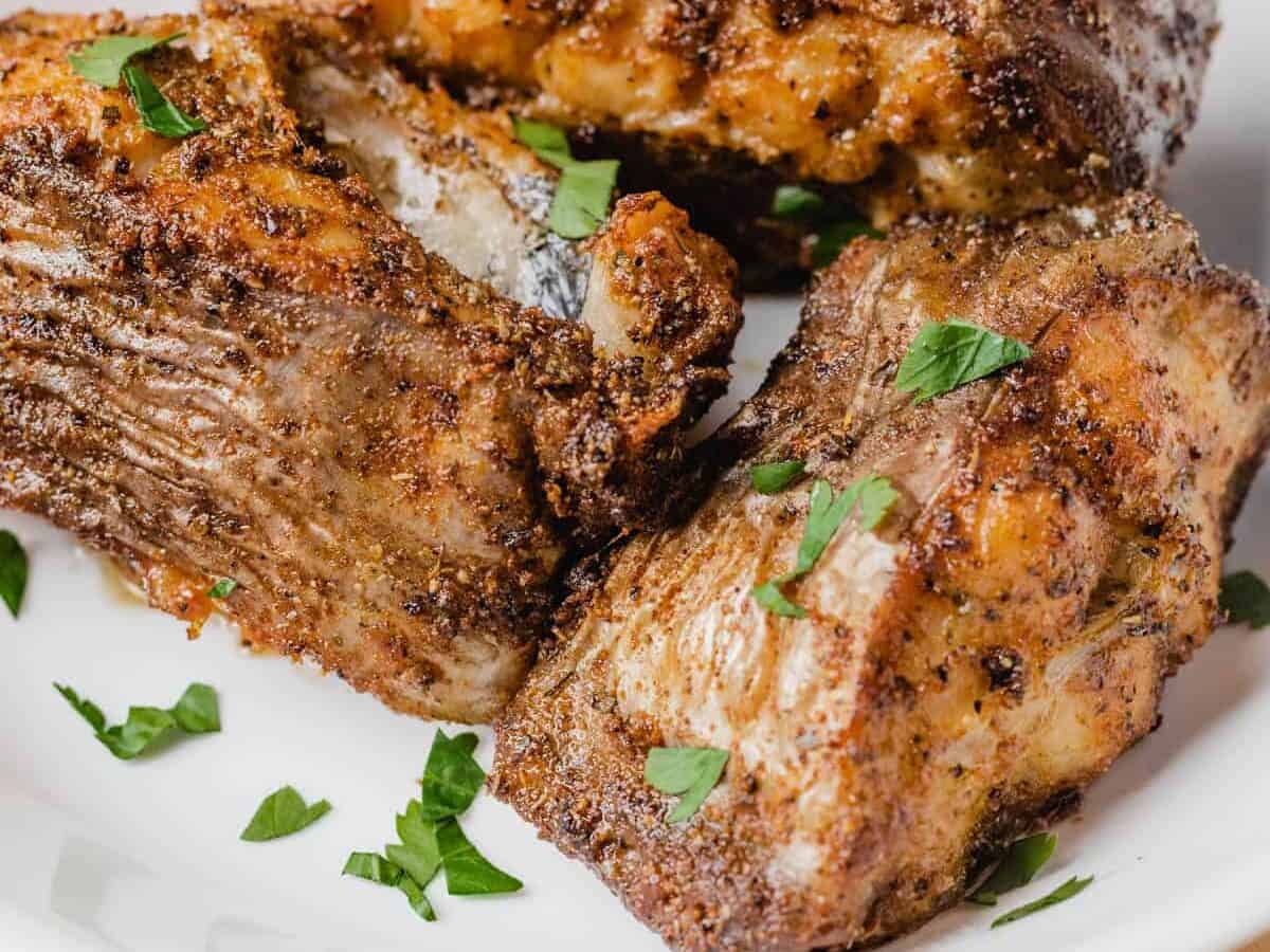 fried catfish steaks on a white plate