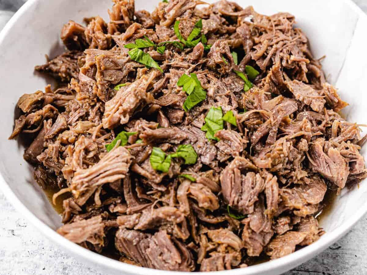 shredded beef in a white bowl