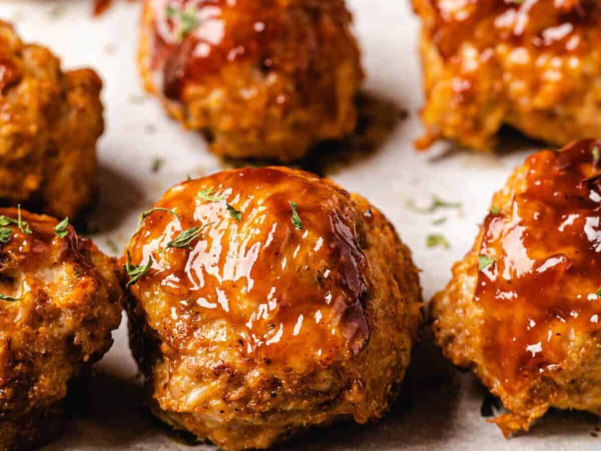 homemade turkey meatballs on a white surface.