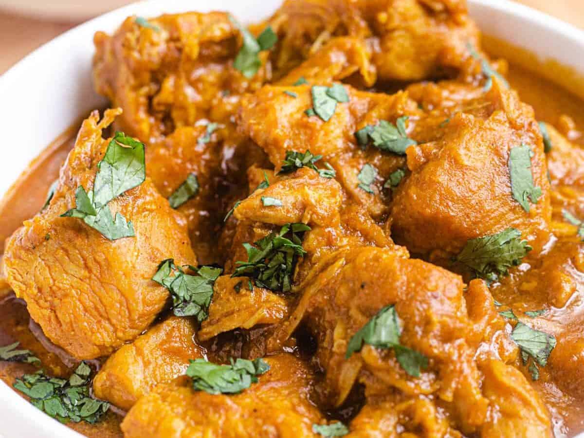 pumpkin chicken curry in a white bowl.