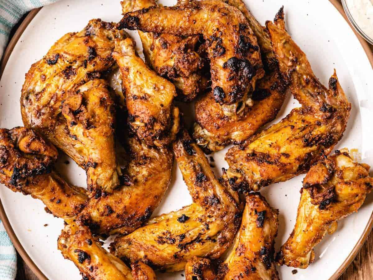 white plate of spicy whole chicken wings.