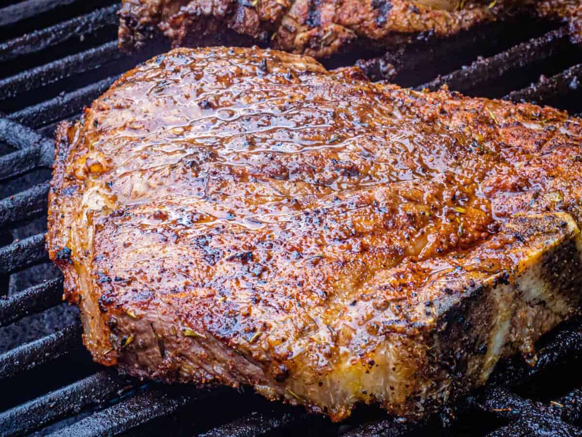 t-bone steak on a grill.