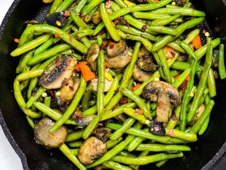 sauteed green beans and mushrooms on a skillet