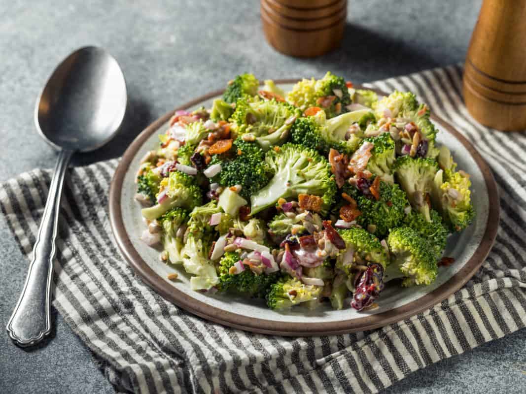plate with broccoli salad with bacon and other ingredients.