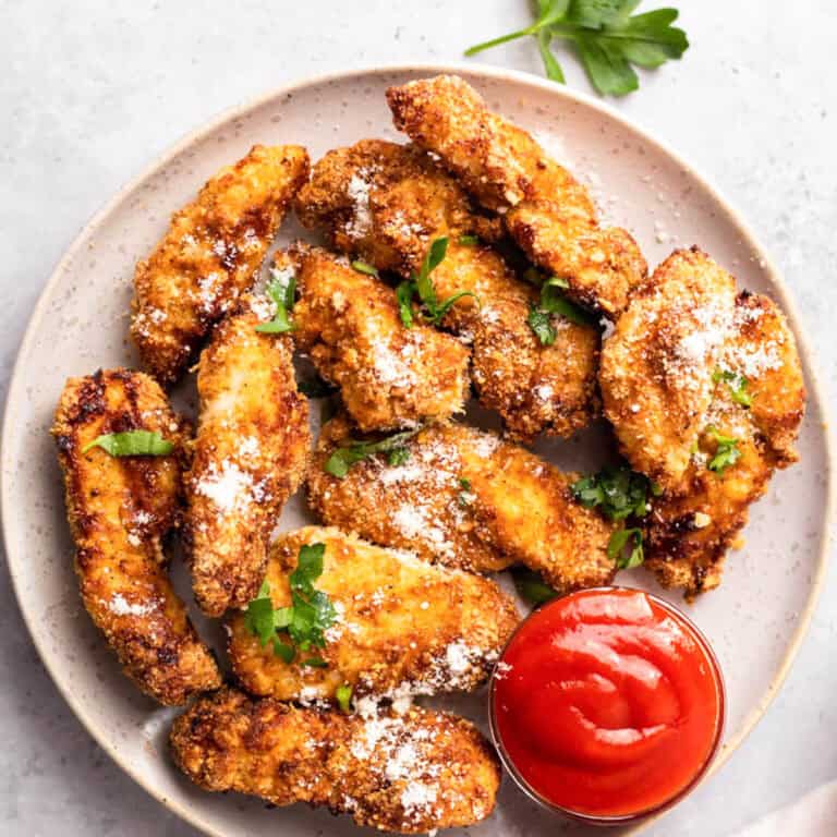 air fried chicken tenders on a plate with sauce
