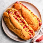 Freshly baked keto hot dog buns with hotdogs