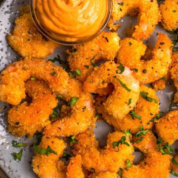 Keto fried shrimp with dipping sauce and garnish