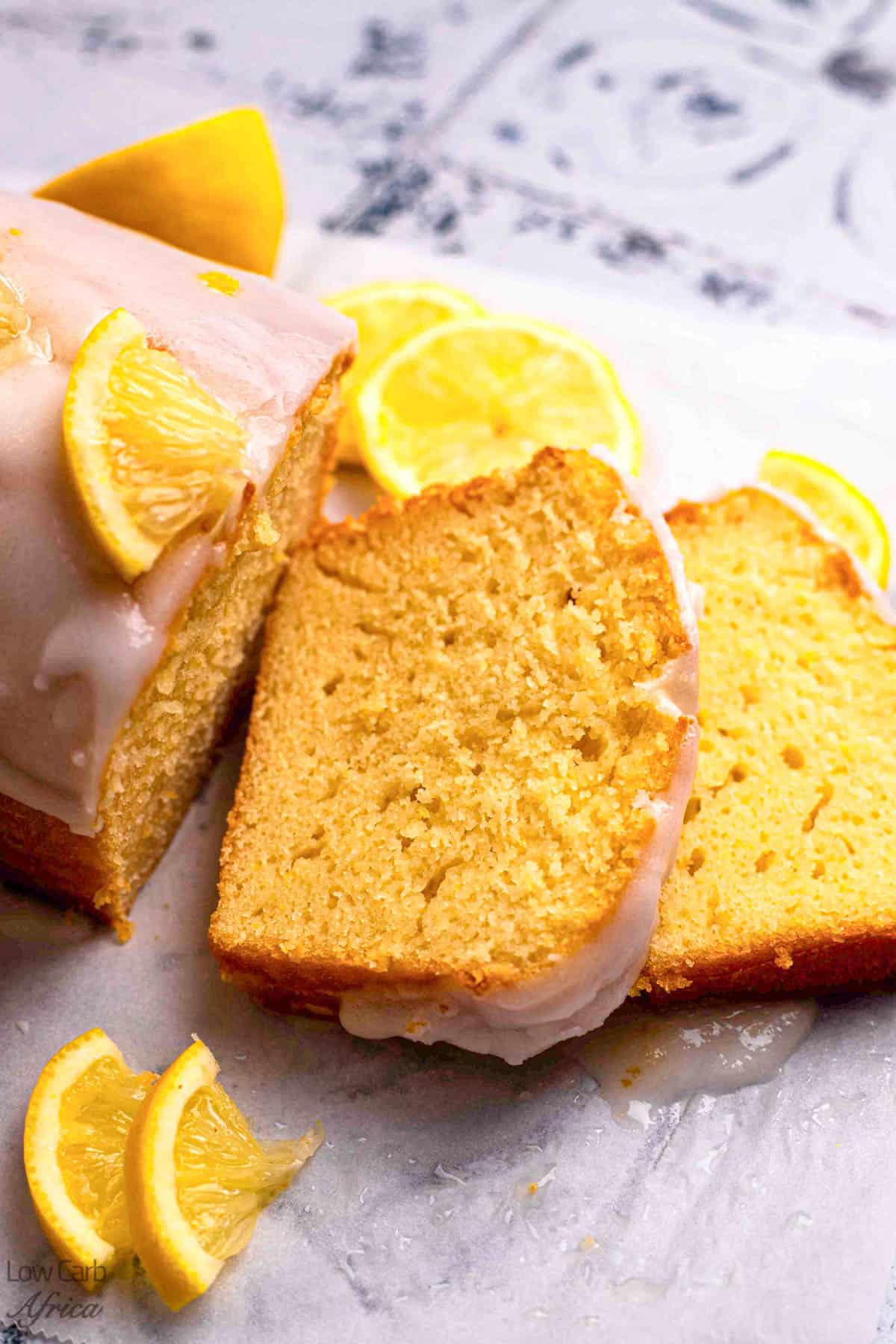 Sliced keto lemon cake with lemon garnish